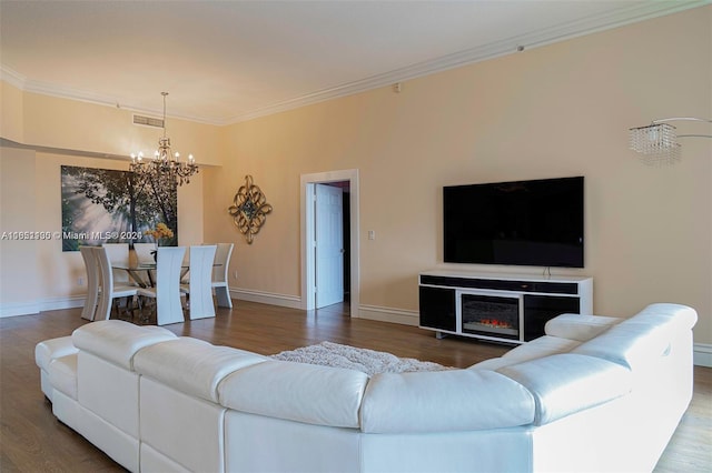 living room featuring a chandelier, ornamental molding, and hardwood / wood-style flooring