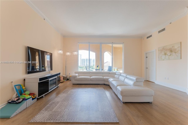 living room featuring light hardwood / wood-style flooring and ornamental molding