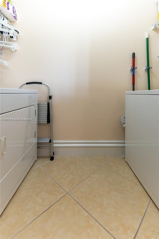 laundry area with tile patterned flooring