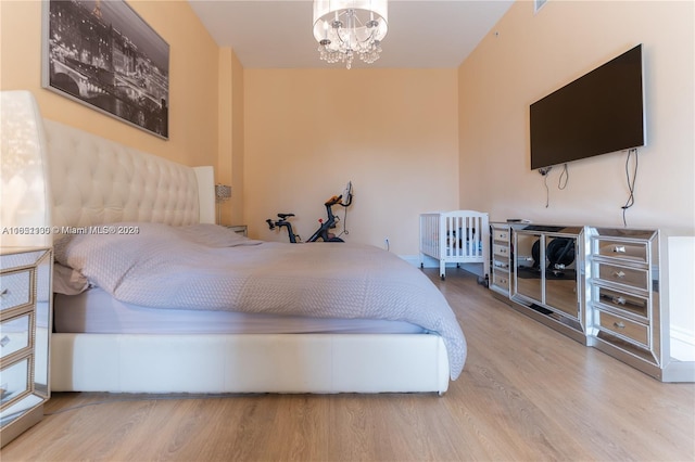 bedroom featuring hardwood / wood-style flooring and a notable chandelier