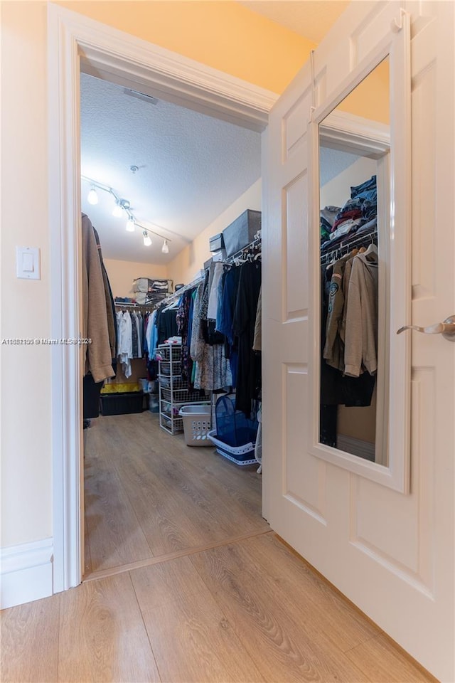 spacious closet with hardwood / wood-style floors