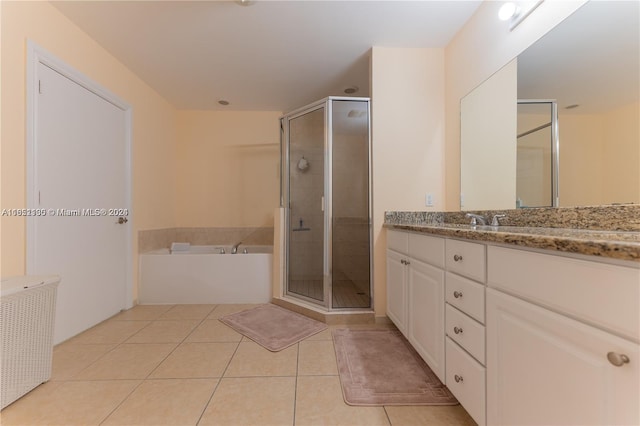 bathroom featuring tile patterned floors, vanity, and shower with separate bathtub