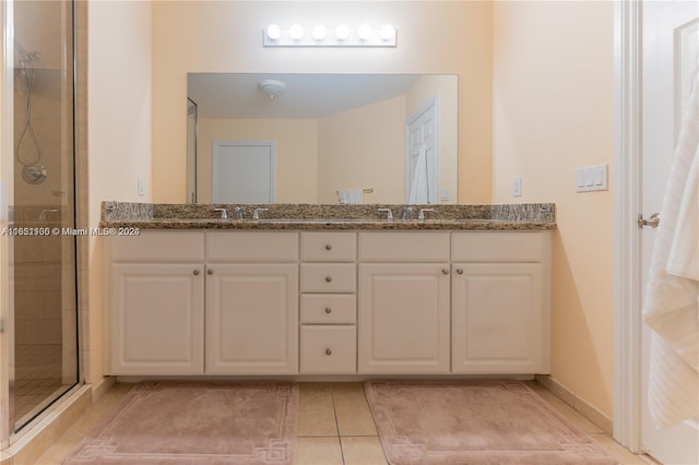 bathroom featuring tile patterned flooring, vanity, and an enclosed shower