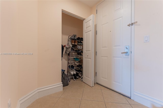 hall with light tile patterned flooring