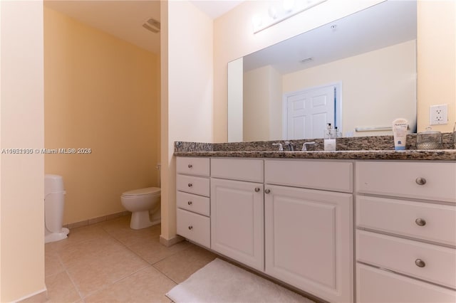 bathroom featuring tile patterned floors, vanity, and toilet