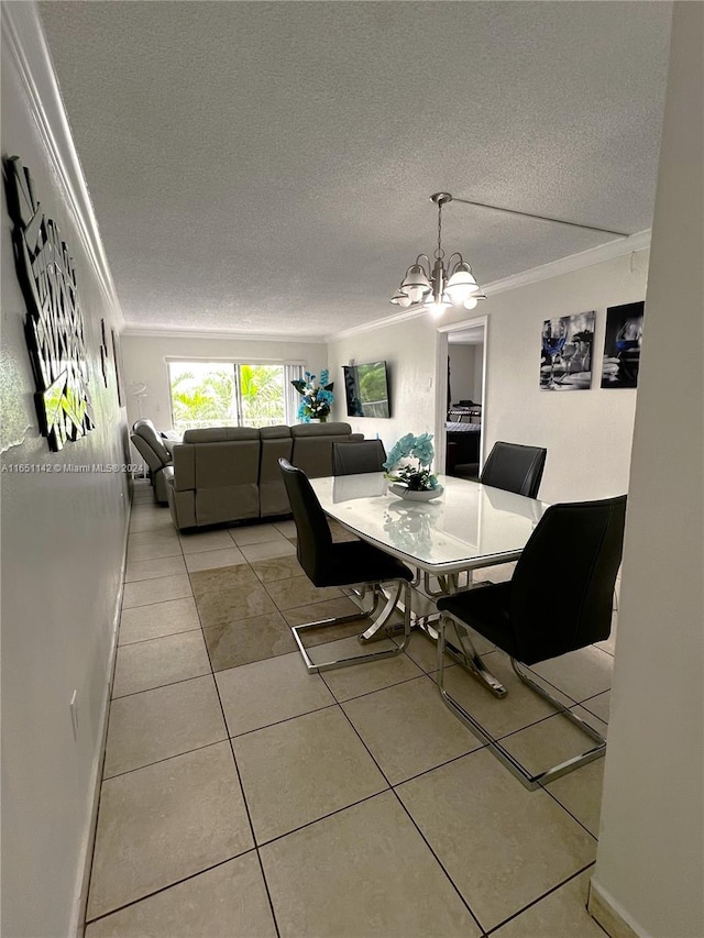 dining area with light tile patterned floors, crown molding, and a textured ceiling