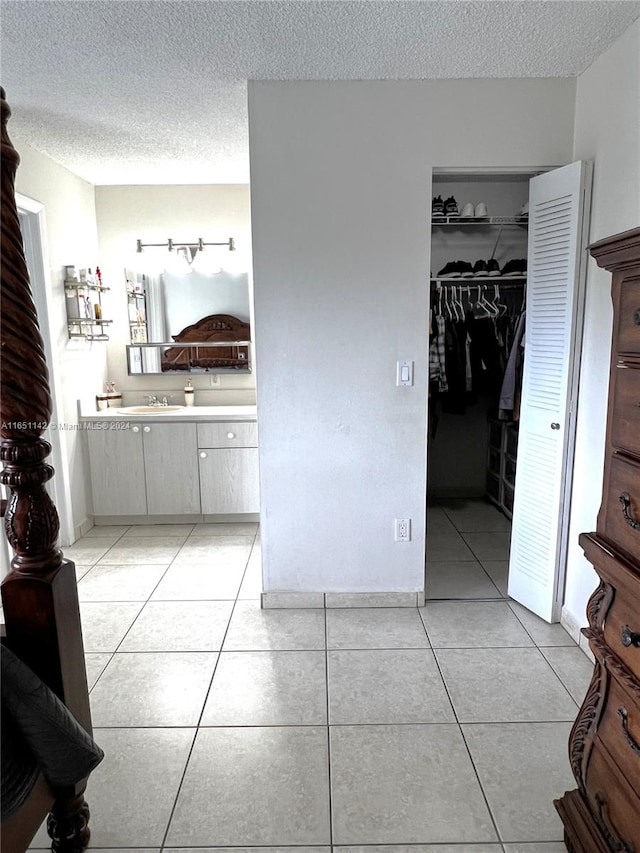 bathroom featuring vanity, a textured ceiling, and tile patterned floors