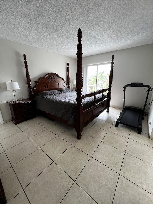 bedroom with a textured ceiling and light tile patterned flooring