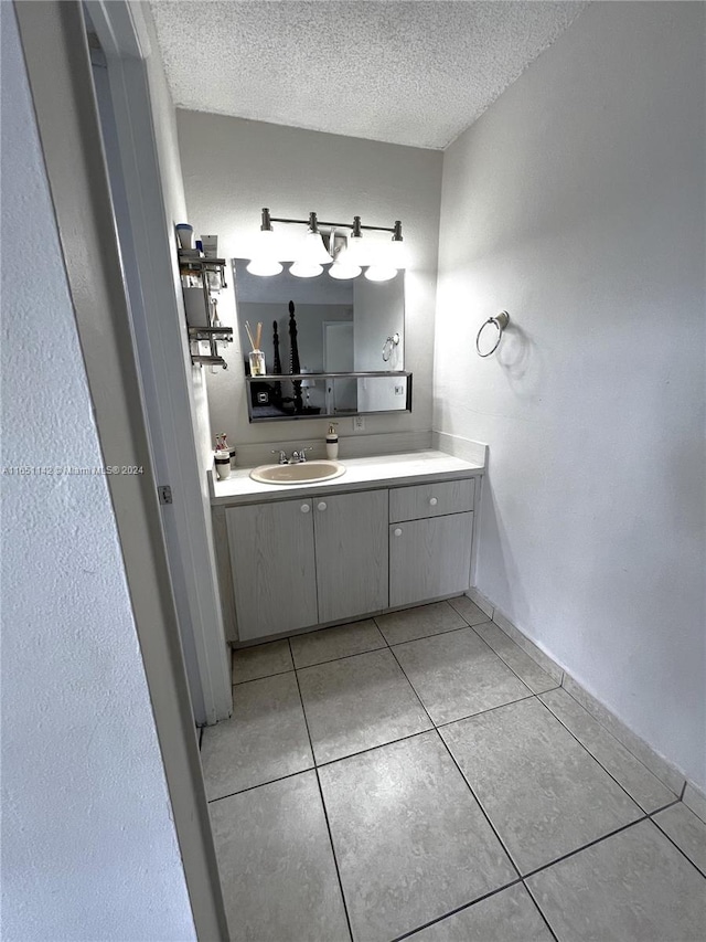 bathroom featuring tile patterned flooring, a textured ceiling, and vanity