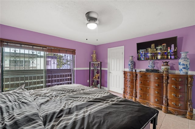 tiled bedroom featuring a textured ceiling and ceiling fan