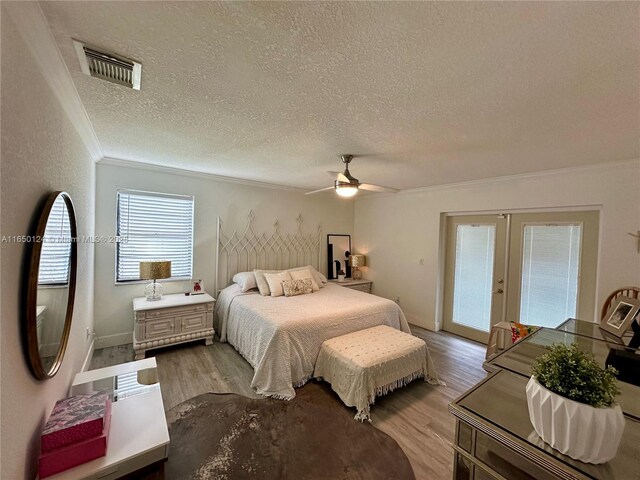 23304 SW 58th Ave Unit B, Boca Raton, FL 33428 - bedroom with a textured ceiling, crown molding, light wood-type flooring, french doors, and access to exterior