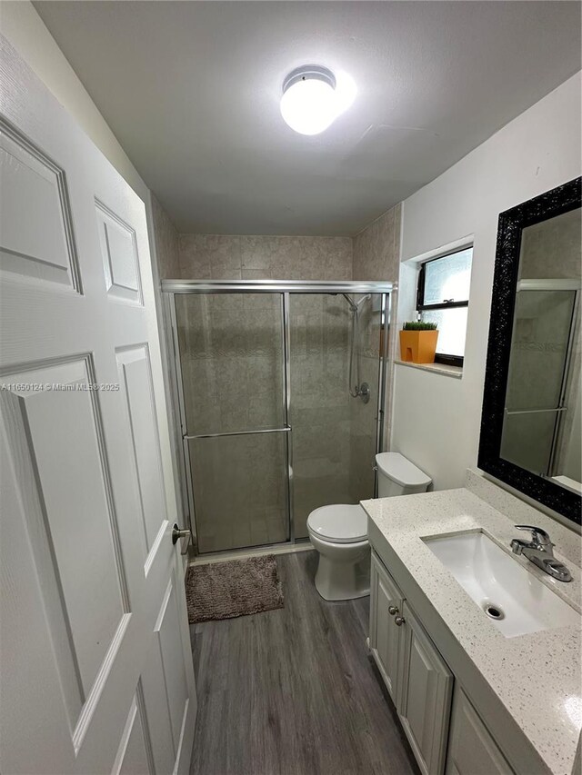 23304 SW 58th Ave Unit B, Boca Raton, FL 33428 - full bath with vanity, toilet, wood finished floors, and a shower stall