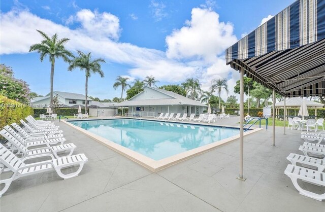 23304 SW 58th Ave Unit B, Boca Raton, FL 33428 - community pool featuring a patio area