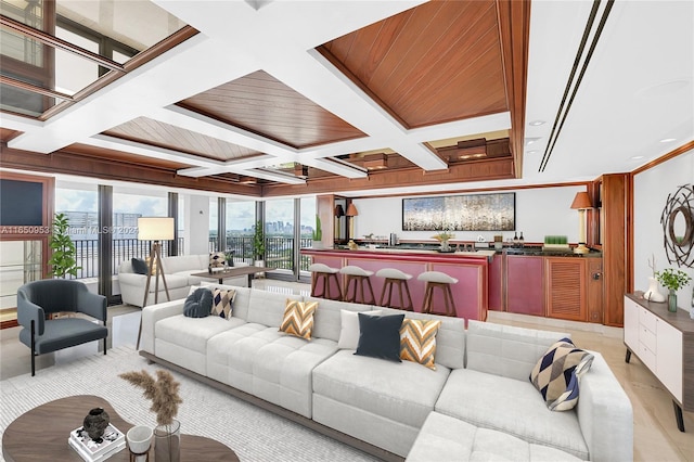 living room with bar area, beamed ceiling, coffered ceiling, and ornamental molding