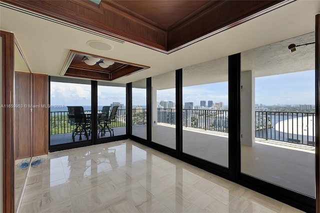 unfurnished room featuring floor to ceiling windows and a raised ceiling