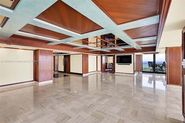 empty room with french doors, beam ceiling, coffered ceiling, and expansive windows