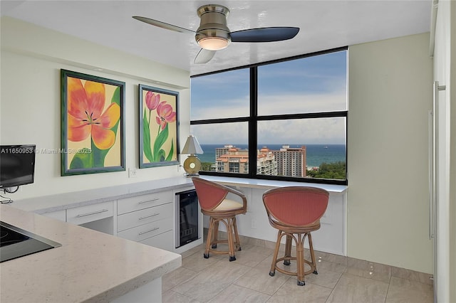 936 Intracoastal Dr Unit Ph4, Fort Lauderdale, FL 33304 - bar area featuring wine cooler, a ceiling fan, and black electric stovetop