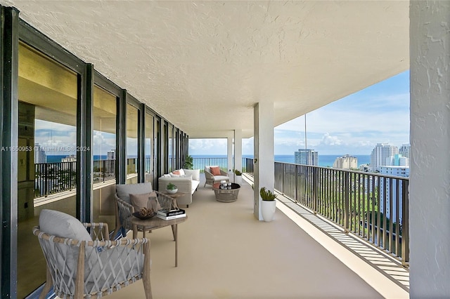 balcony with a water view and outdoor lounge area