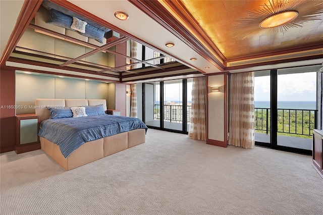 carpeted bedroom with access to exterior and a water view