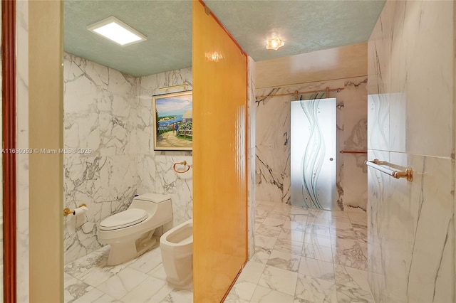 936 Intracoastal Dr Unit Ph4, Fort Lauderdale, FL 33304 - bathroom featuring a bidet, toilet, marble finish flooring, and a textured ceiling