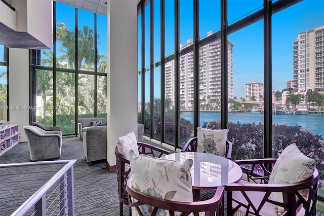 sunroom / solarium with a water view