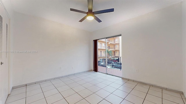 tiled empty room with ceiling fan