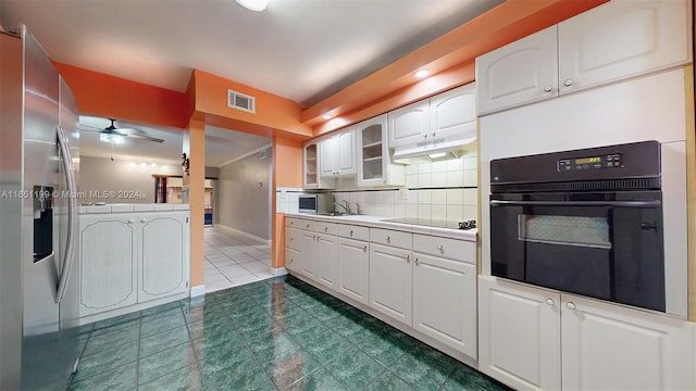 kitchen with white cabinetry, backsplash, black appliances, ceiling fan, and dark tile patterned floors