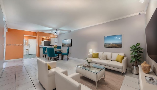 living room featuring ceiling fan, light tile patterned flooring, and ornamental molding