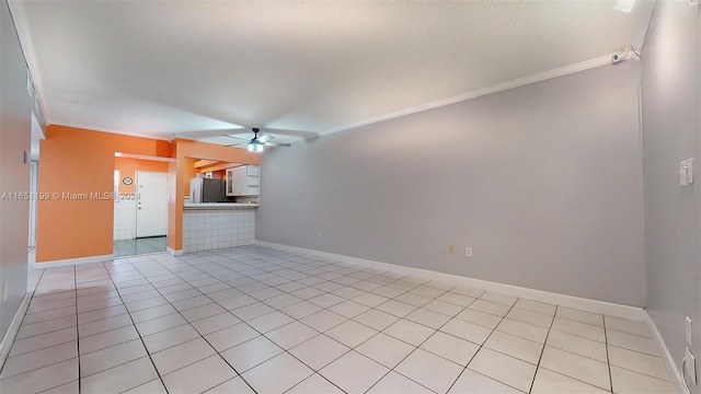 unfurnished living room featuring ceiling fan, crown molding, and light tile patterned floors