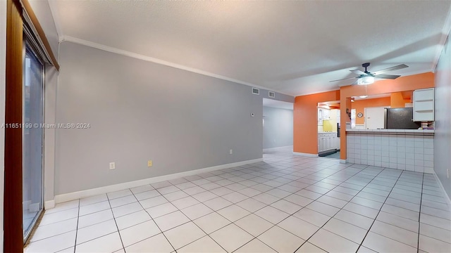 unfurnished living room featuring crown molding, light tile patterned flooring, and ceiling fan