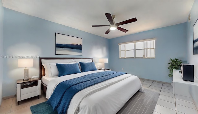 tiled bedroom featuring ceiling fan