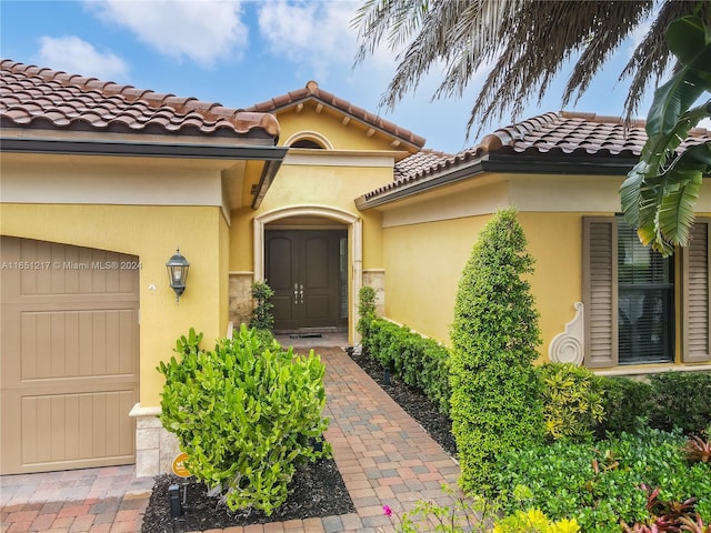 view of exterior entry featuring a garage