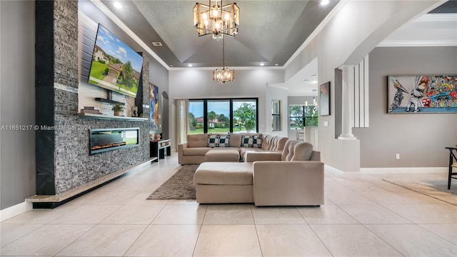 living room featuring a textured ceiling, a notable chandelier, a stone fireplace, light tile patterned floors, and crown molding