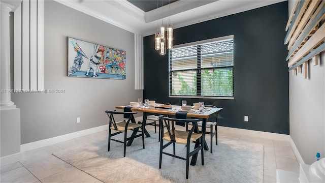 tiled dining room featuring ornamental molding and ornate columns