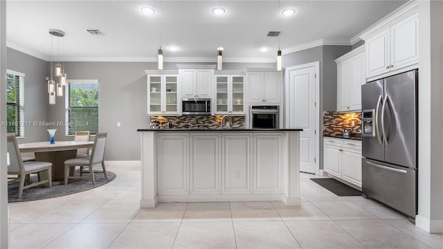 kitchen featuring appliances with stainless steel finishes, backsplash, white cabinets, and pendant lighting