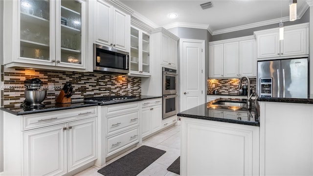 kitchen with pendant lighting, stainless steel appliances, ornamental molding, sink, and decorative backsplash