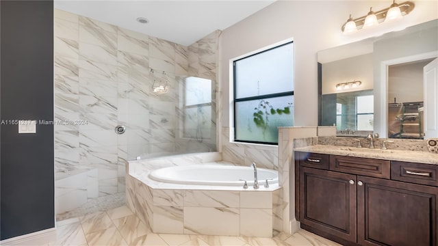 bathroom featuring vanity and separate shower and tub