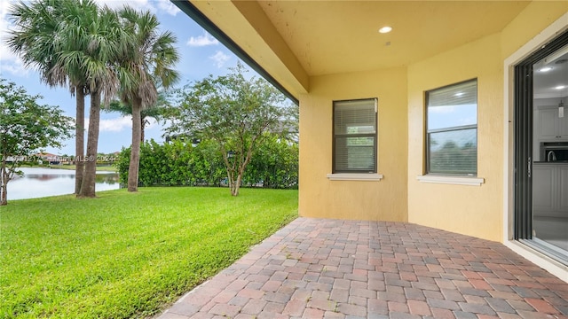 view of patio with a water view