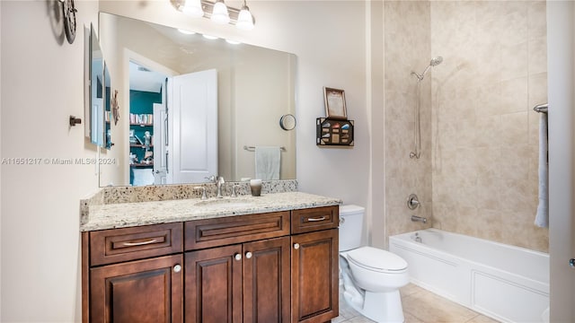 full bathroom with tile patterned floors, toilet, tiled shower / bath combo, and vanity