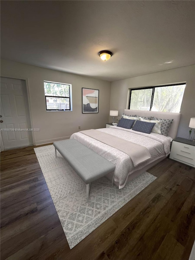 bedroom with a closet, ceiling fan, and dark hardwood / wood-style floors