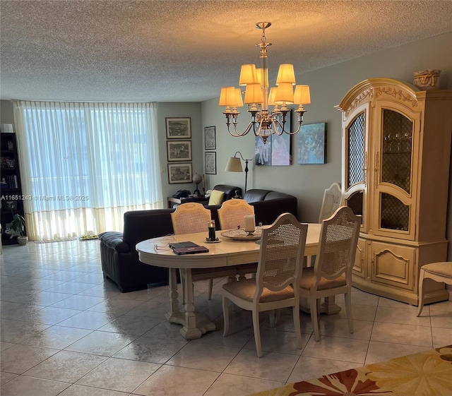 dining space with light tile patterned floors, a chandelier, and a textured ceiling