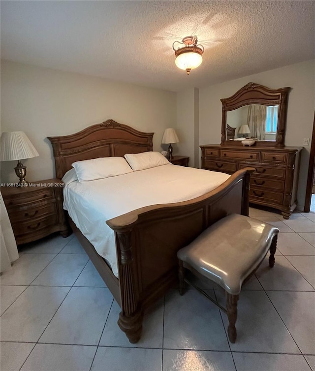 bedroom with light tile patterned flooring and a textured ceiling