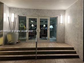 entrance to property with stucco siding and french doors