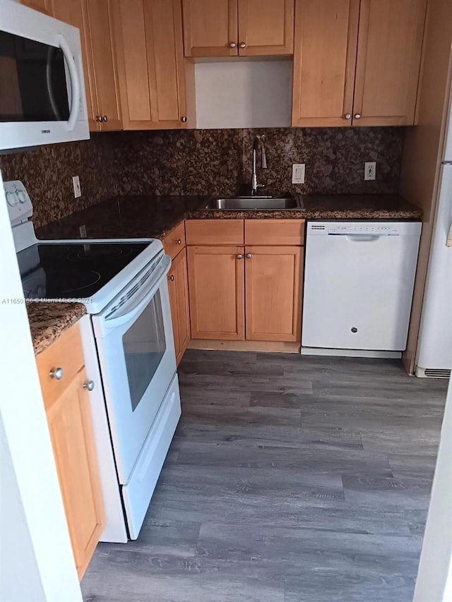 kitchen with white appliances, backsplash, dark hardwood / wood-style floors, and sink