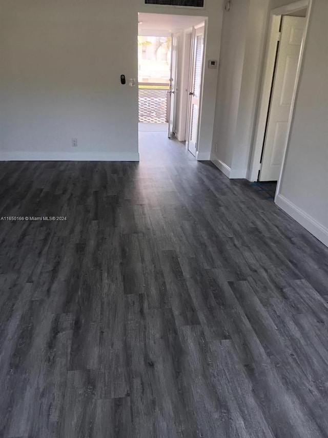 empty room featuring dark wood-type flooring