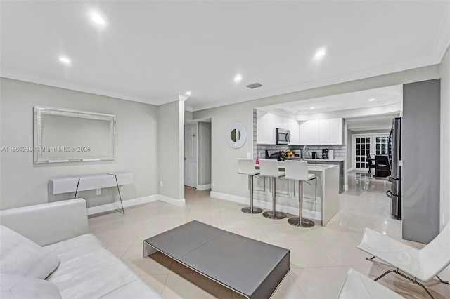 living room featuring light tile patterned flooring and ornamental molding