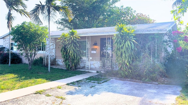 view of front of home featuring a front yard and a porch