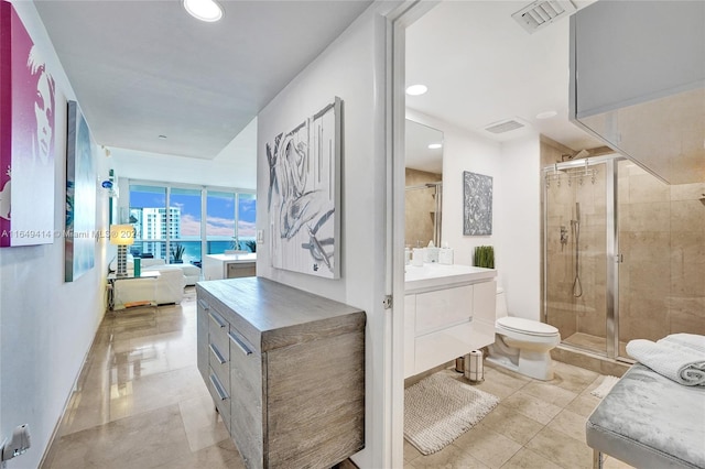 bathroom with vanity, toilet, and an enclosed shower