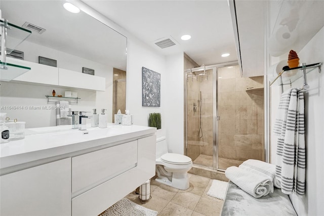 bathroom with vanity, toilet, an enclosed shower, and tile patterned floors