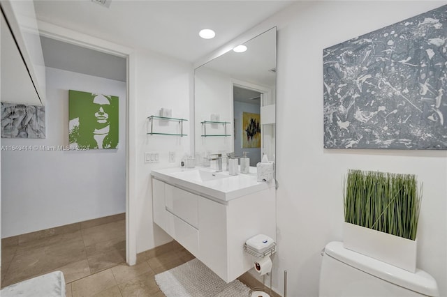 bathroom with vanity, toilet, and tile patterned floors